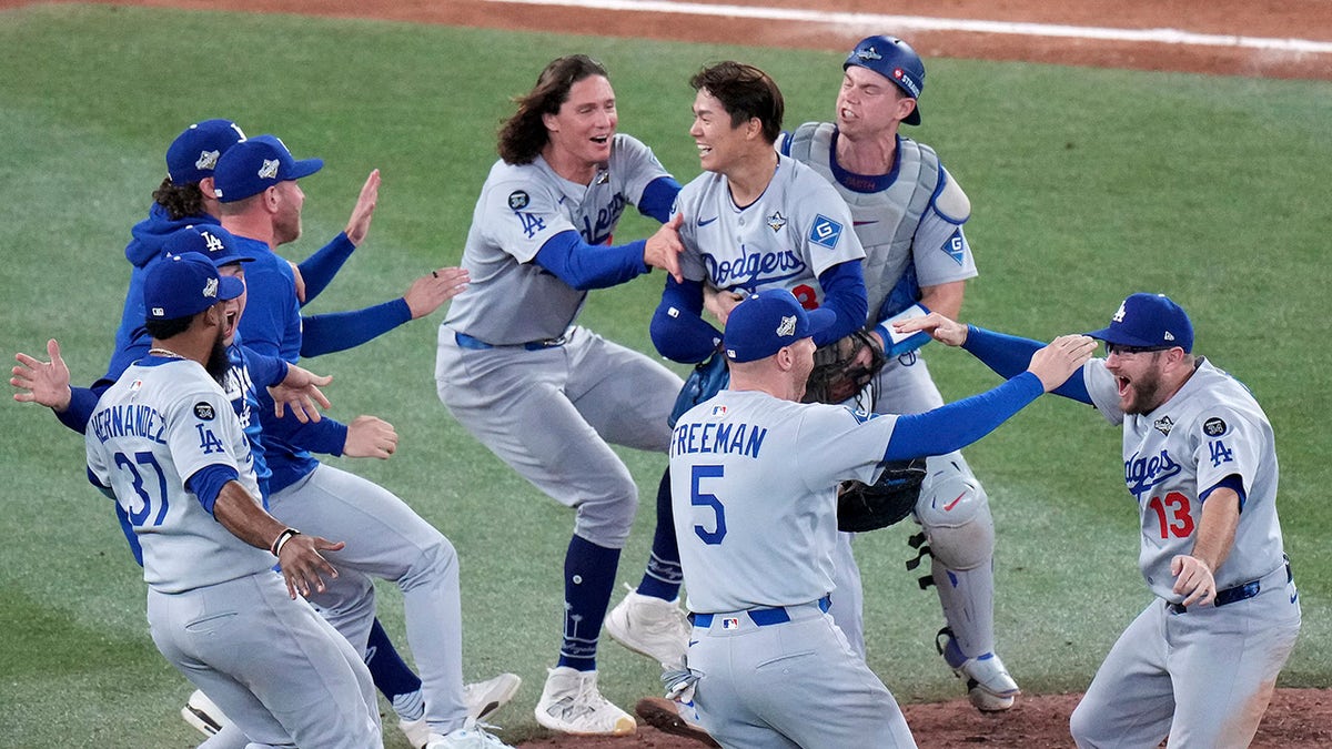 Los Angeles Dodgers pitcher Yoshinobu Yamamoto (18) celebrates with teammates after the team defeated the Toronto Blue Jays in Game 7 of baseball's World Series, Sunday, Nov. 2, 2025, in Toronto.