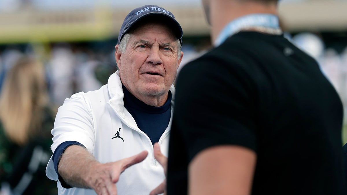 Bill Belichick greets a recruit
