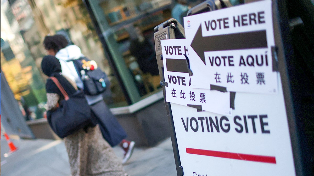 People walk by a voting site in NYC