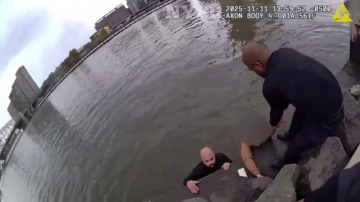 Officers pull the girl from the water.