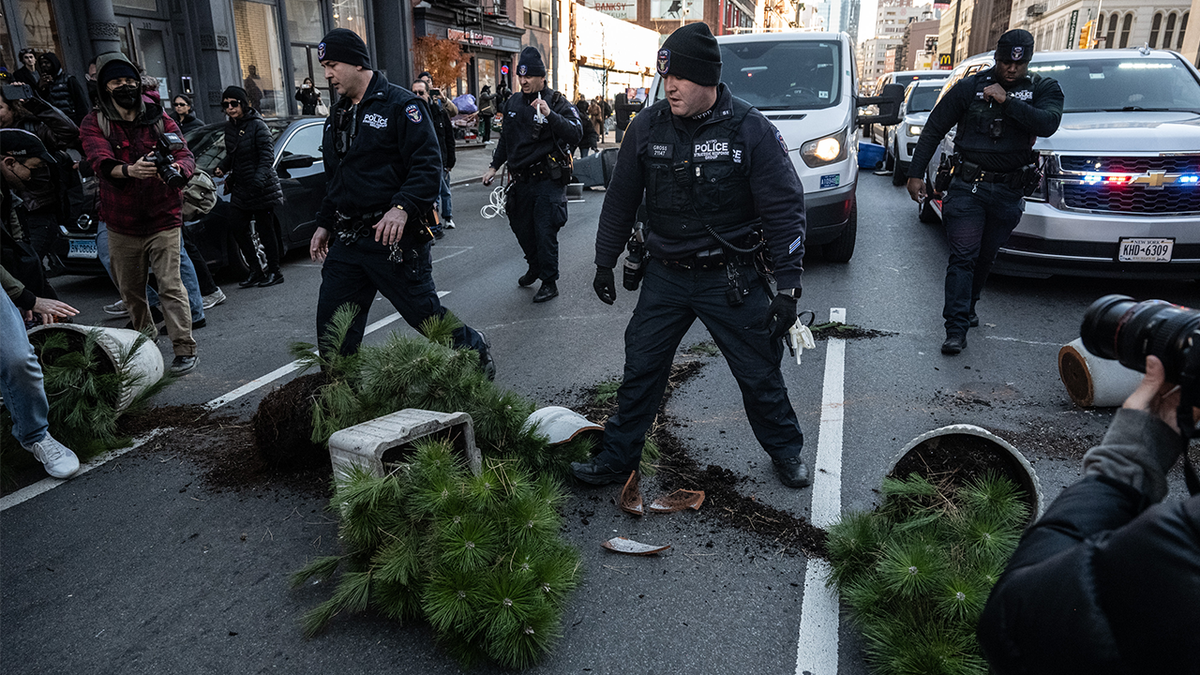 Immigration activists block ICE vans during a protest against a purported ICE raid on Canal Street on November 29, 2025 in New York City. Activists assembled outside of a garage used by ICE and later they tried to block ICE vehicles as they traveled from the garage down Canal Street to the Holland Tunnel to exit Manhattan.