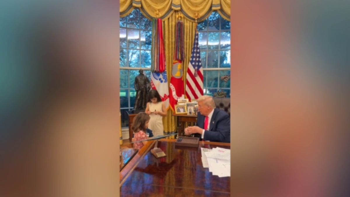 President Trump offers White House pens to visiting kids in Oval Office.