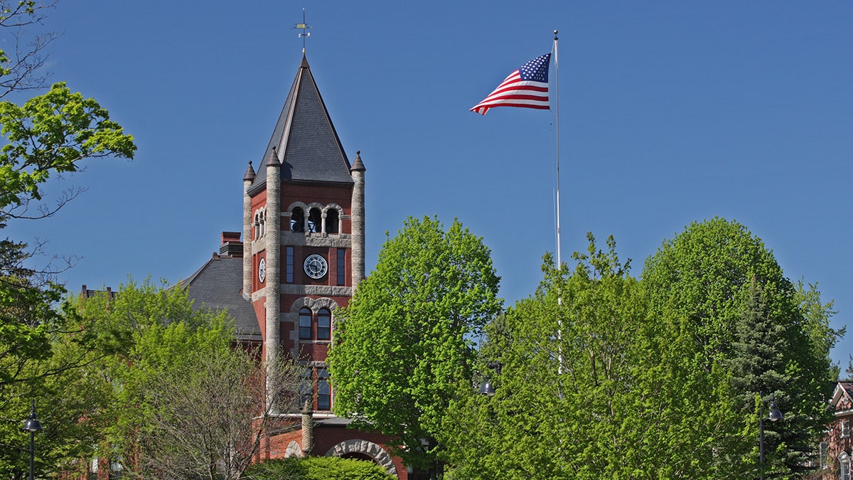 Brick building and American flag on University of New Hampshire campus
