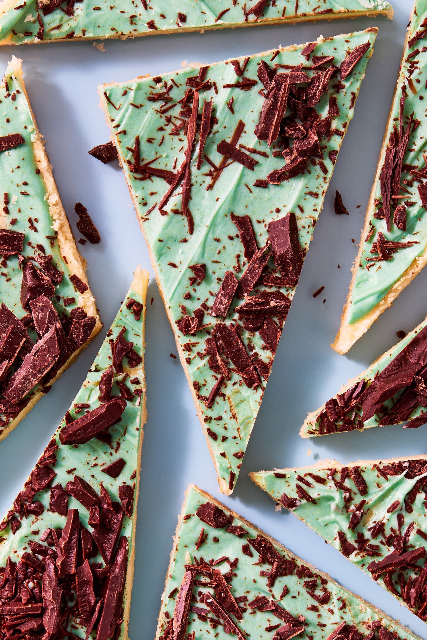 An overhead image of mint-green triangles topped with chocolate shavings.
