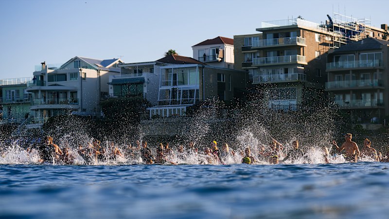 Emotional scenes as thousands paddle out in Bondi