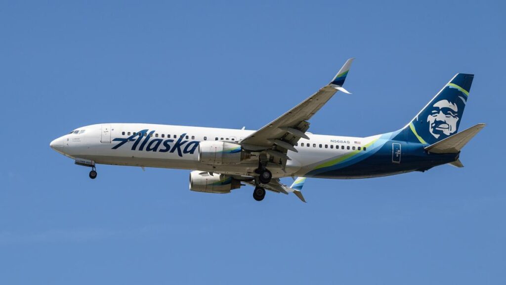 Out-of-control Alaska Airlines passenger tries to opens plane door mid-flight