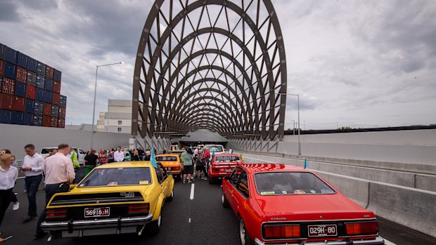 Vintage and classic cars line up before going through the tunnel on Saturday.