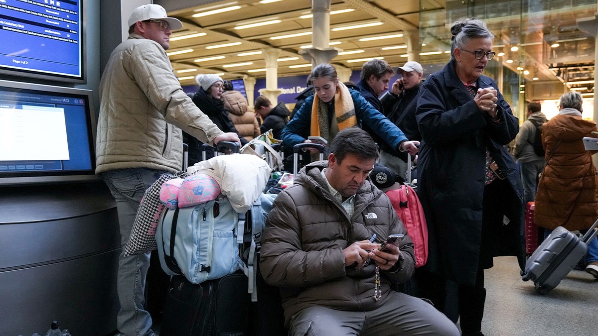 Passengers wait after Eurostar suspends service