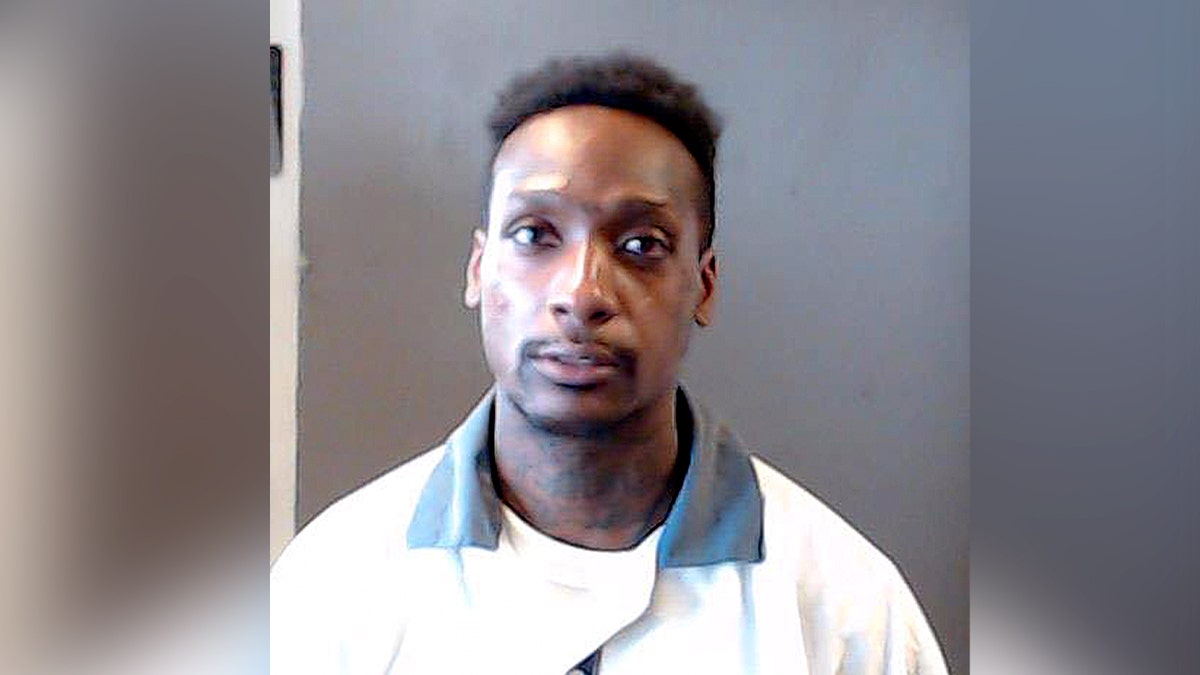 mugshot of man in white shirt