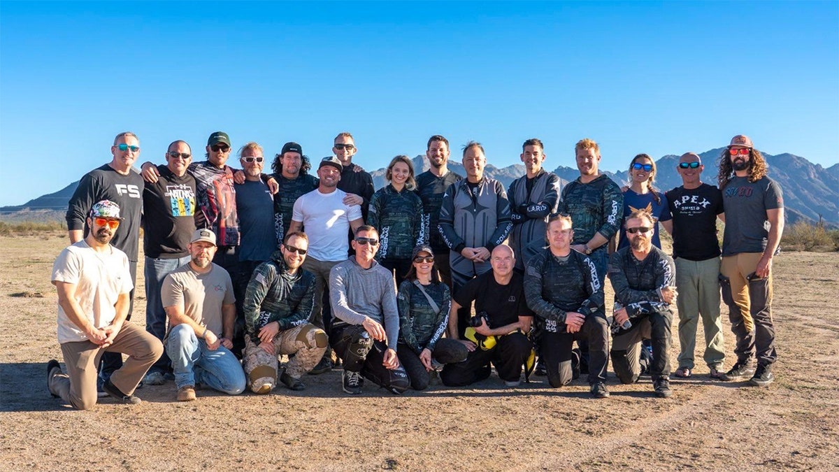The full skydiving team posed together on the ground during the world-record flag freefall attempt.