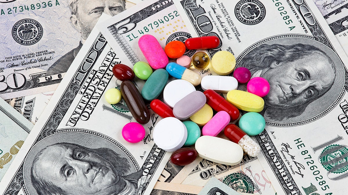 An image of a pile of pills on top of a stack of money