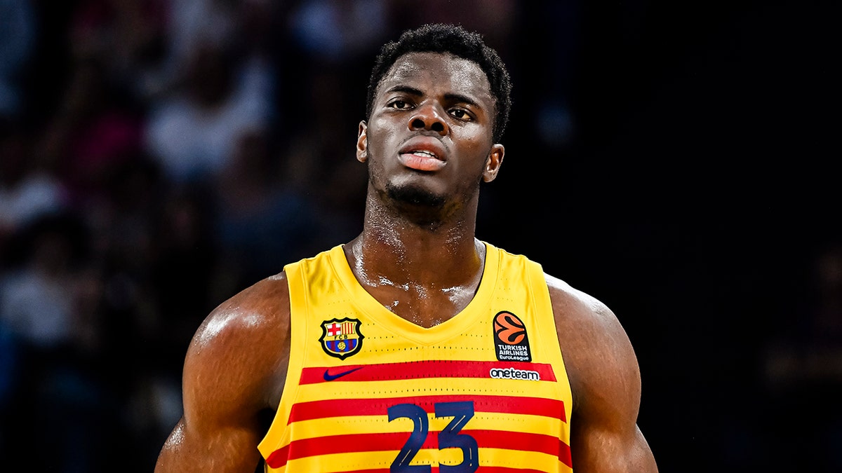 James Nnaji looks on court