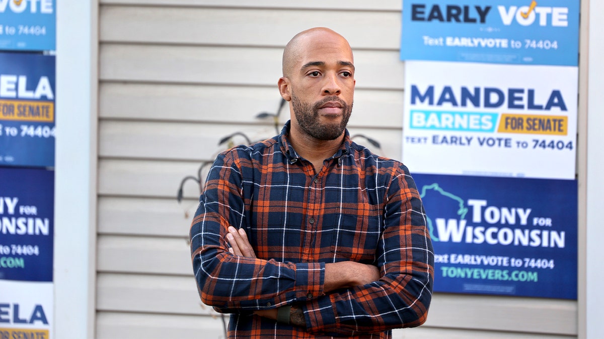 Mandela Barnes stands among supporters at a campaign rally in Madison.