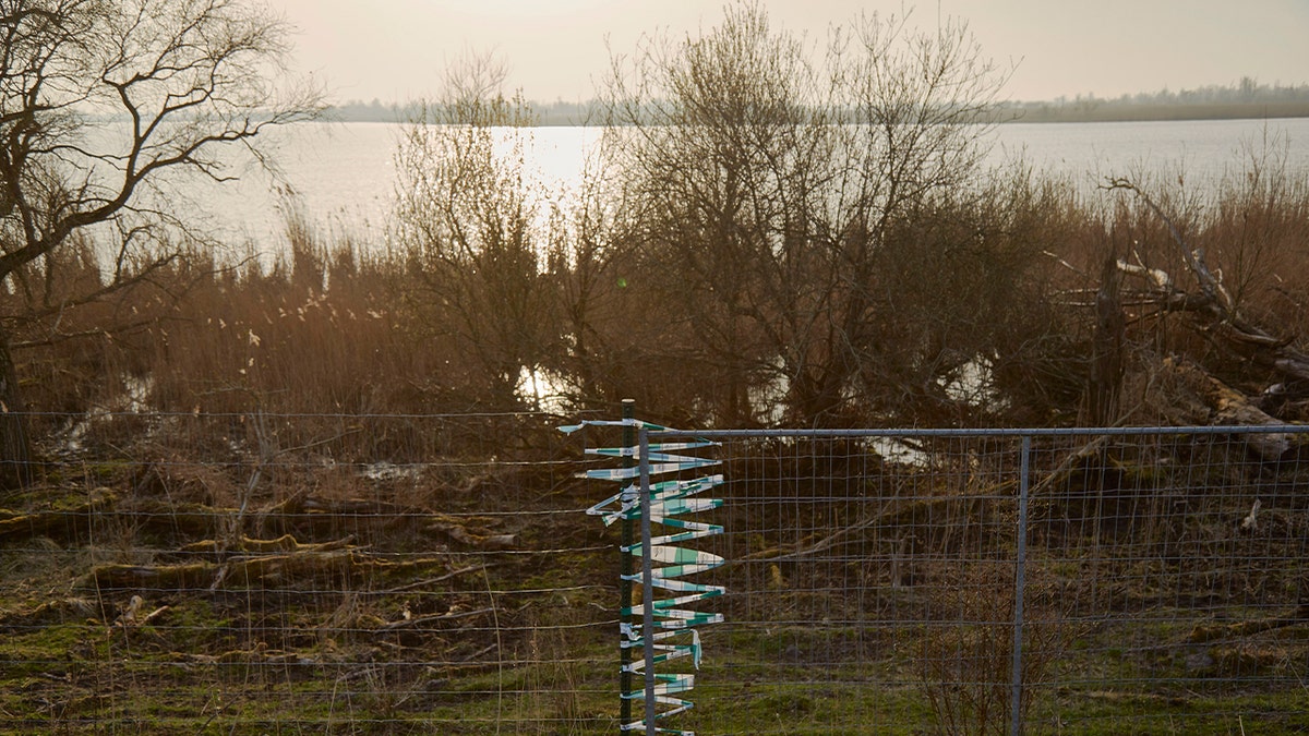 Fence around large lake.