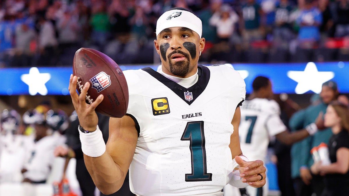 Jalen Hurts warms up for the game