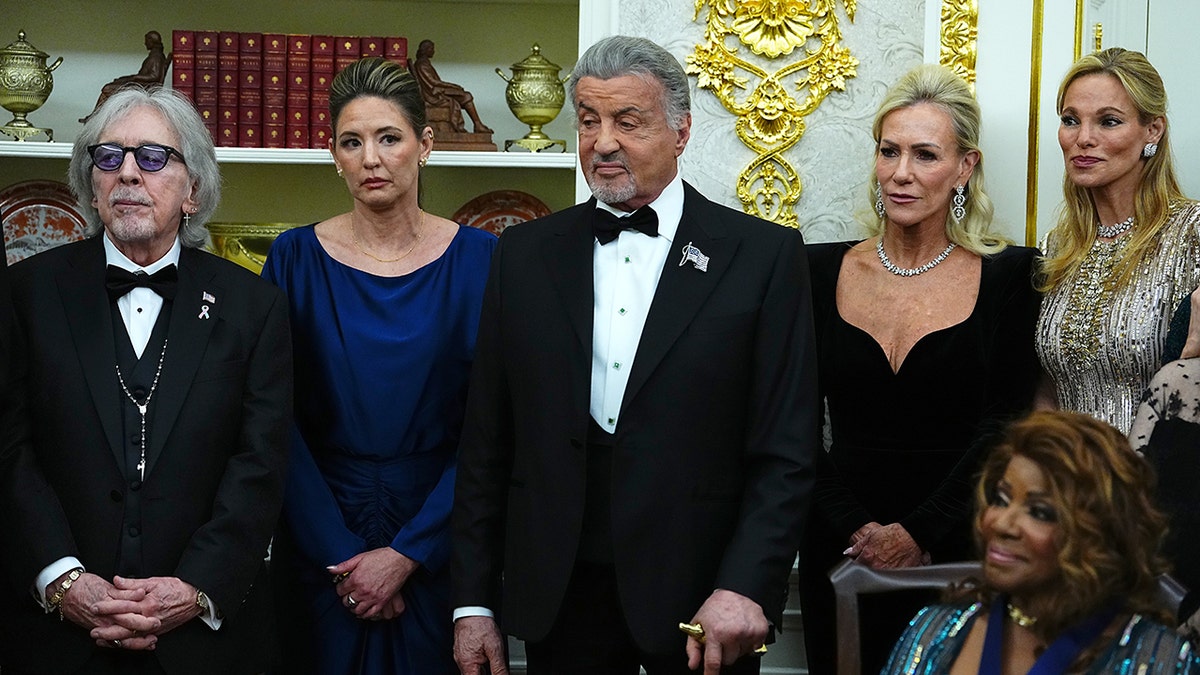 Sylvester Stallone flanked by other Kennedy Center honorees at the Oval Office