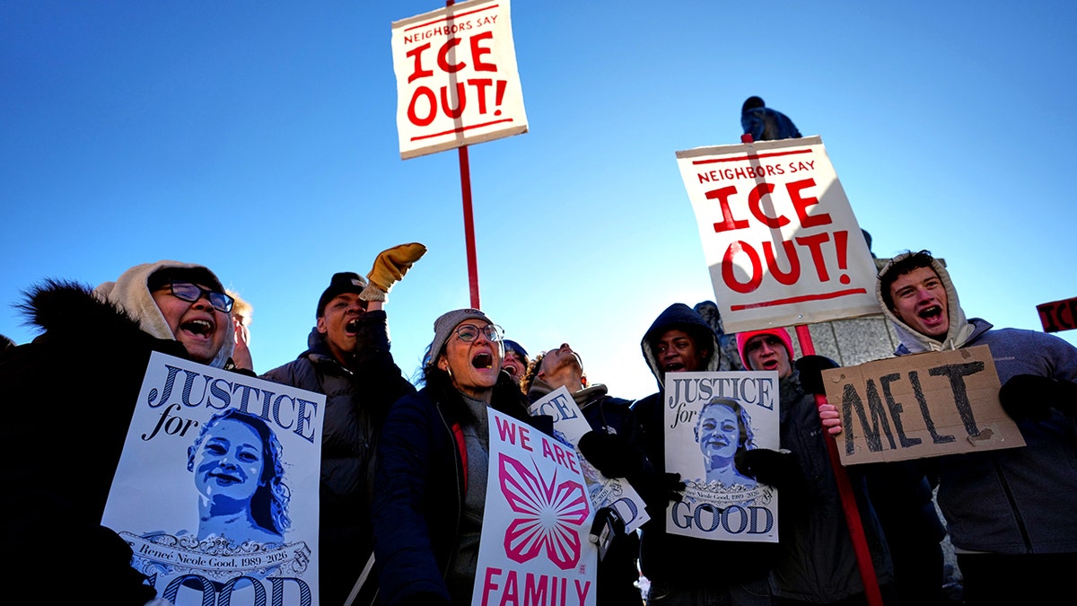 Anti-ICE protesters holding signs
