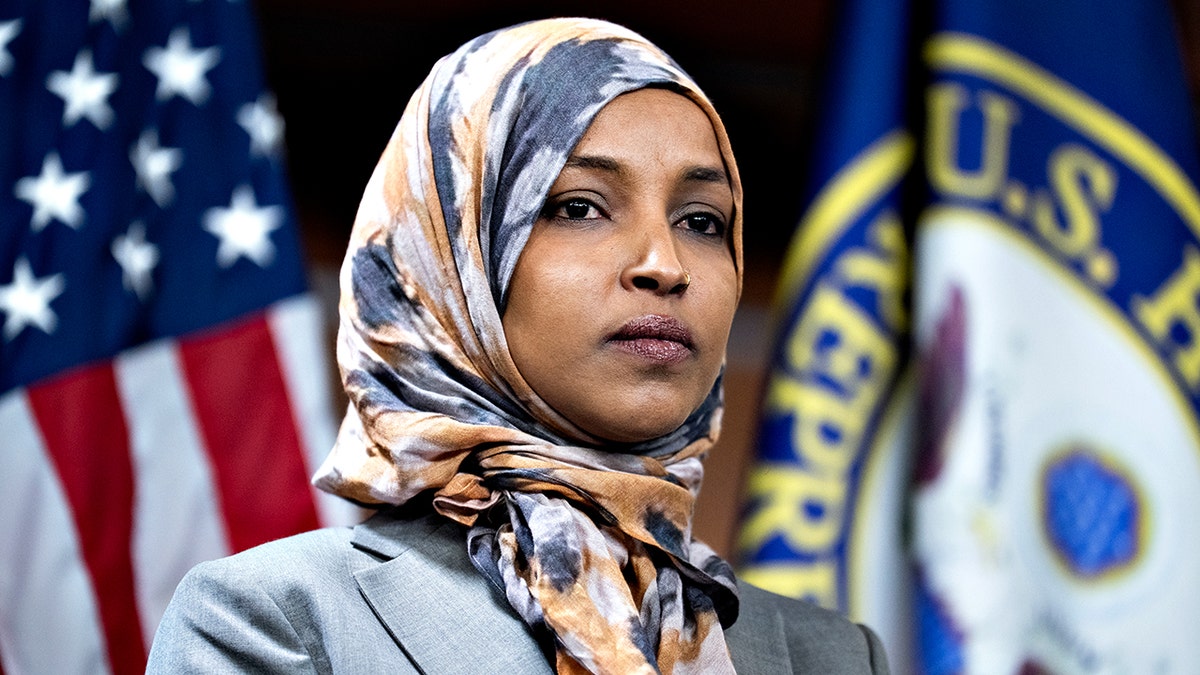 Ilhan Omar looking on at news conference