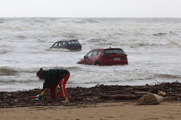 Locals begin cleaning up in Wye River on Friday morning after intense flooding. 