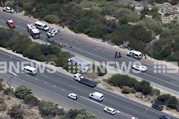 A FedEx truck was bogged in dirt on the opposite side of the highway. 