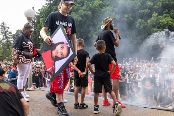Protesters hold a poster of Sophie Quinn, who was fatally shot at Lake Cargelligo.