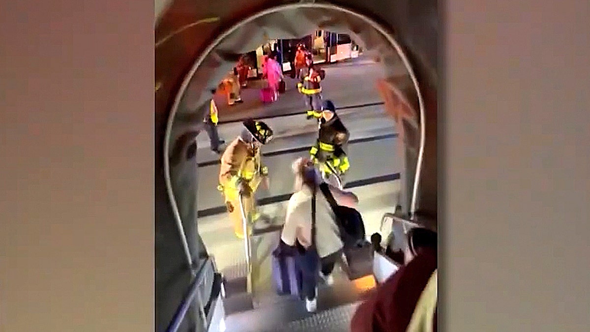 passengers evacuating plane