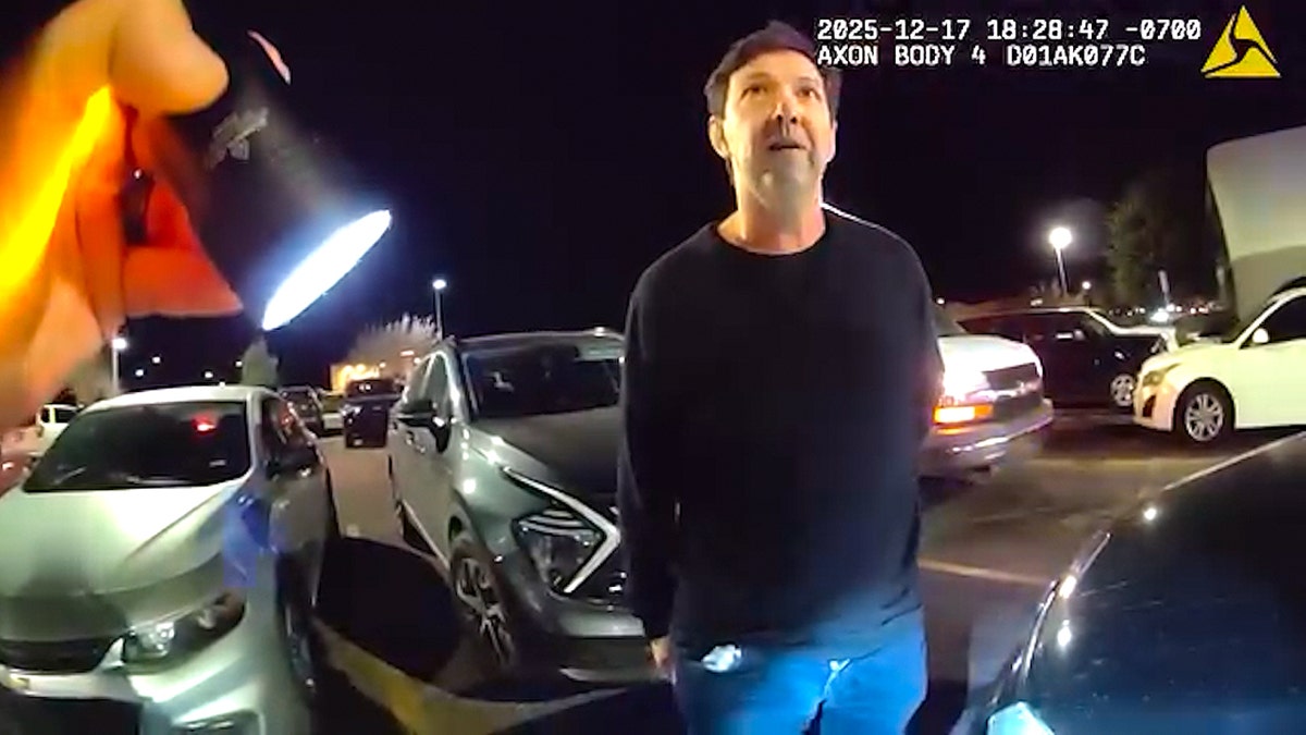 Paul Correa talking to police on body cam while officer holds flash light
