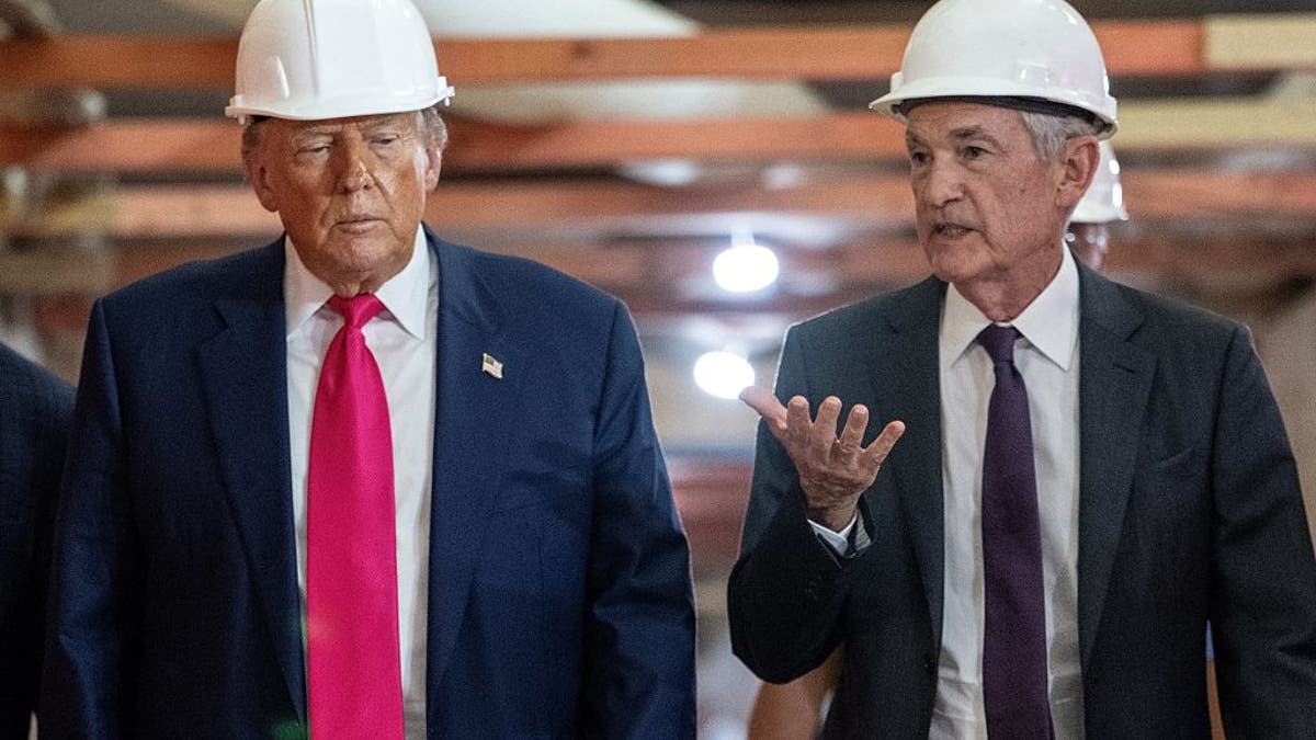 President Donald Trump speaks with Federal Reserve chair Jerome Powell (R) as he visits the Federal Reserve in Washington, D.C., on July 24, 2025.Â