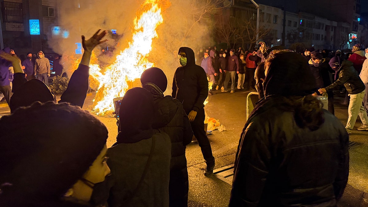 Fire in street as Iranians protest in Tehran