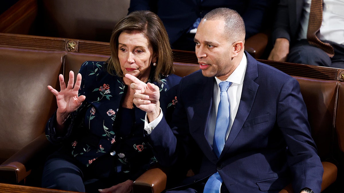 Nancy Pelosi, left, sits next to Hakeem Jeffries, right, in the chamber of the U.S. House of Representatives