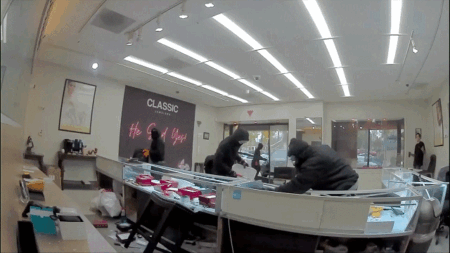 Video shows masked robbers crash car through jewelry store entrance, steal owner's gun in brazen heist