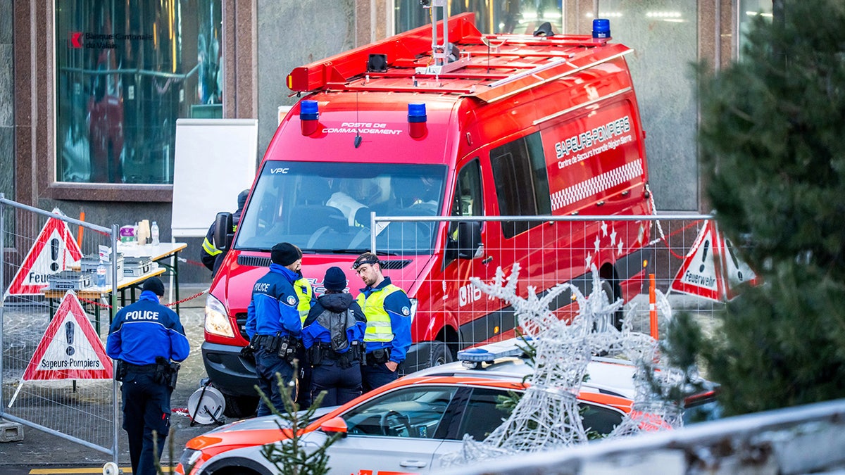 First responders stand outside scene of Switzerland bar fire