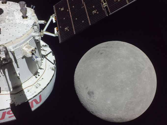 A spacecraft in front of the farside of the moon, which has different features than the side normally facing the Earth