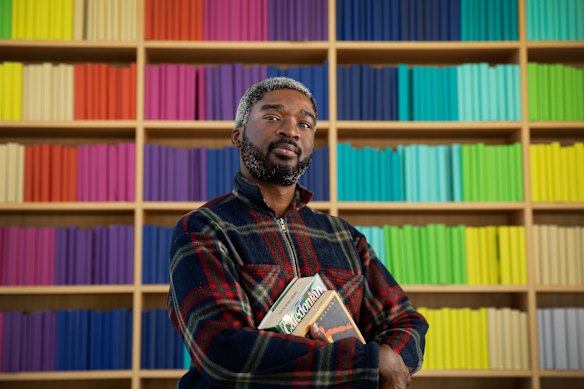 Joseph Damilare at Green Square library, which he visits before or after work every day.