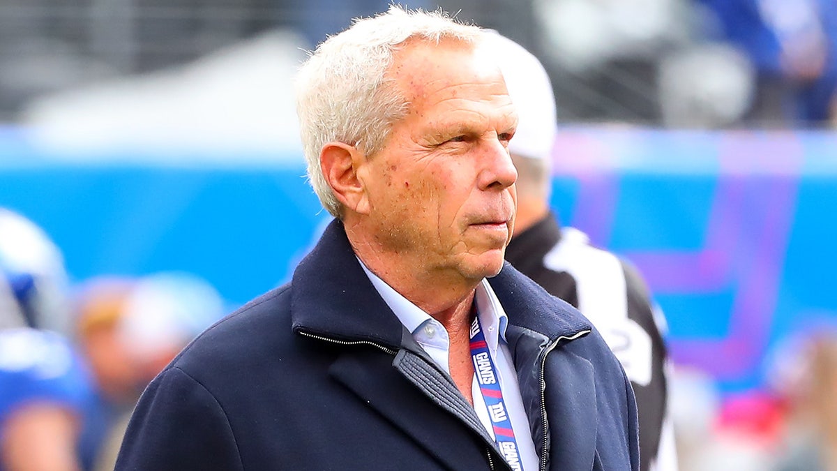 Steve Tisch walks the sideline