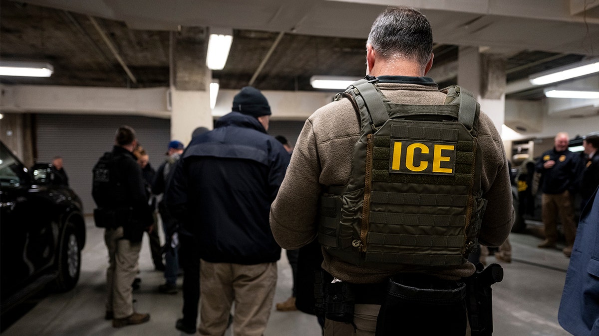 ICE agents are seen in a garage