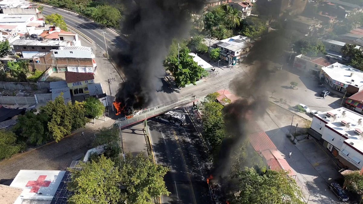 Smoke billows from burning vehicles amid a wave of violence, with torched vehicles and gunmen blocking highways in more than half a dozen states, following a military operation in which a government source said Mexican drug lord Nemesio Oseguera, known as "El Mencho," was killed, in Puerto Vallarta, Jalisco, Mexico, Feb. 22, 2026.Â