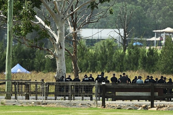 Police conduct a line search on Pitt Town Bottoms Road near where the remains were found on Tuesday.