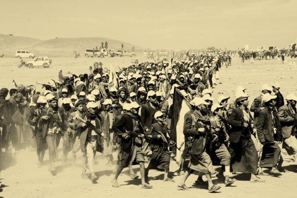 Houthi fighters rally in support of Palestinians in the Gaza Strip and against the US strikes on Yemen in a march outside the capital, Sanaa, in January 2024.  

