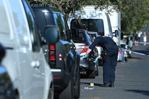 A NSW Police forensic officer processes the crime scene in Greenacre where former NRL player Matt Utai was shot.