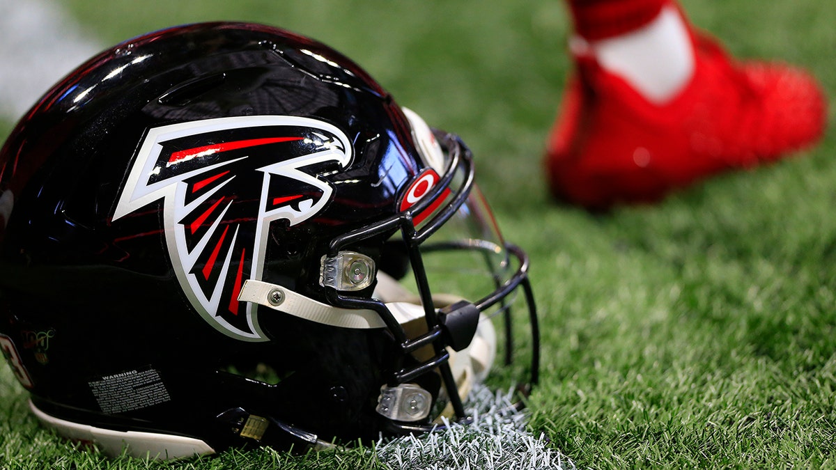 A Falcons helmet sits on the field turf