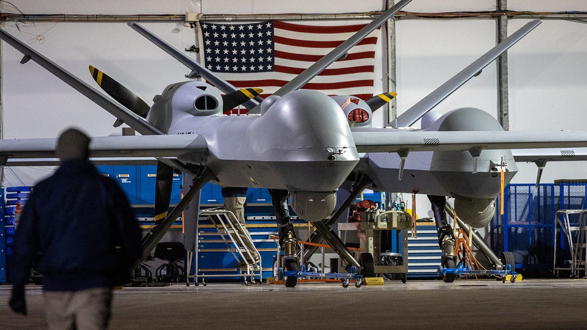 MQ-9 Reaper drone with an American flag in the background.