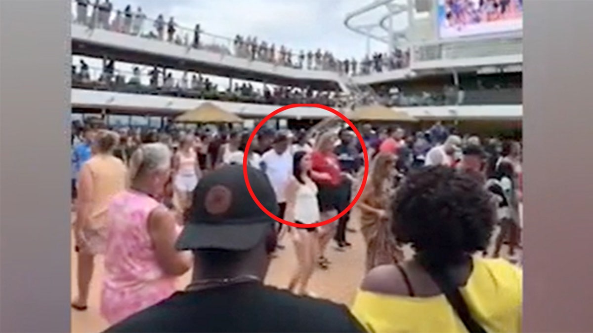 Anna Kepner, wearing black shorts and a white tank top, is seen dancing on a Carnival Cruise.