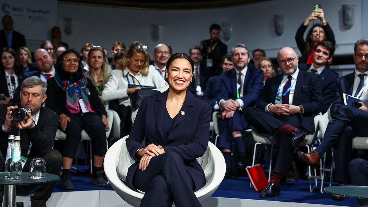 Rep. Alexandria Ocasio-Cortez smiles while attending Munich Security Conference