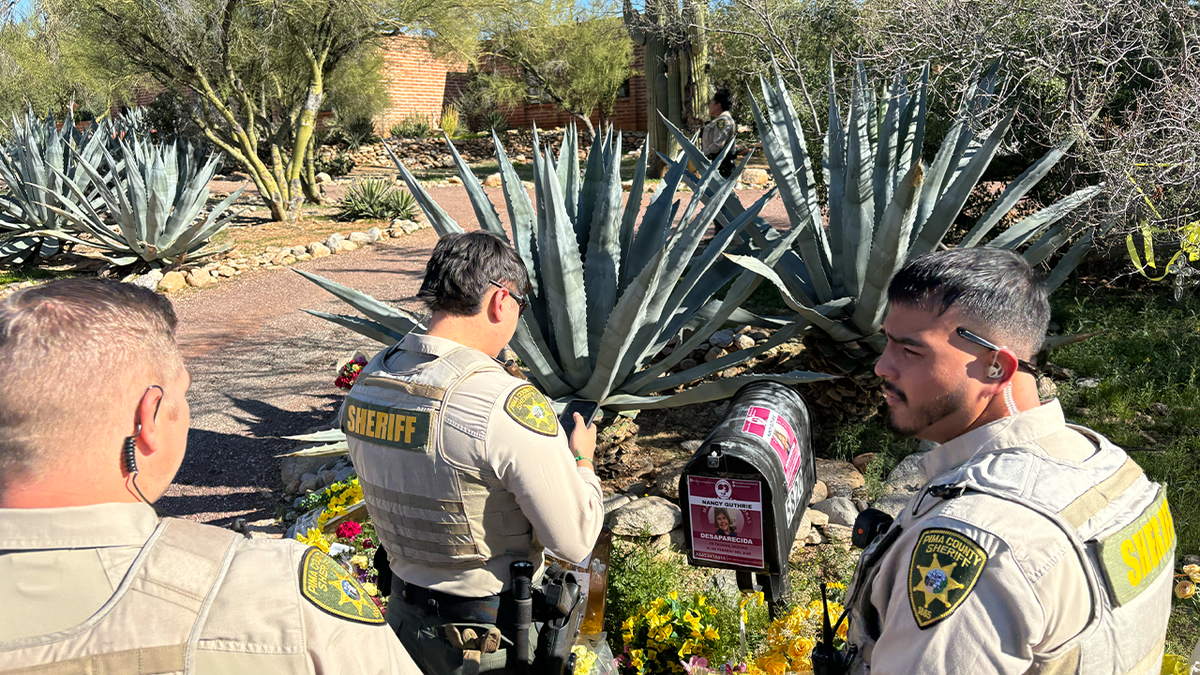 Deputies outside Nancy Guthrie's home.
