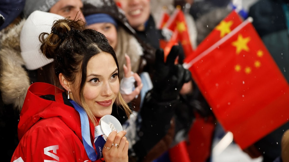 Eileen Gu holding silver medal