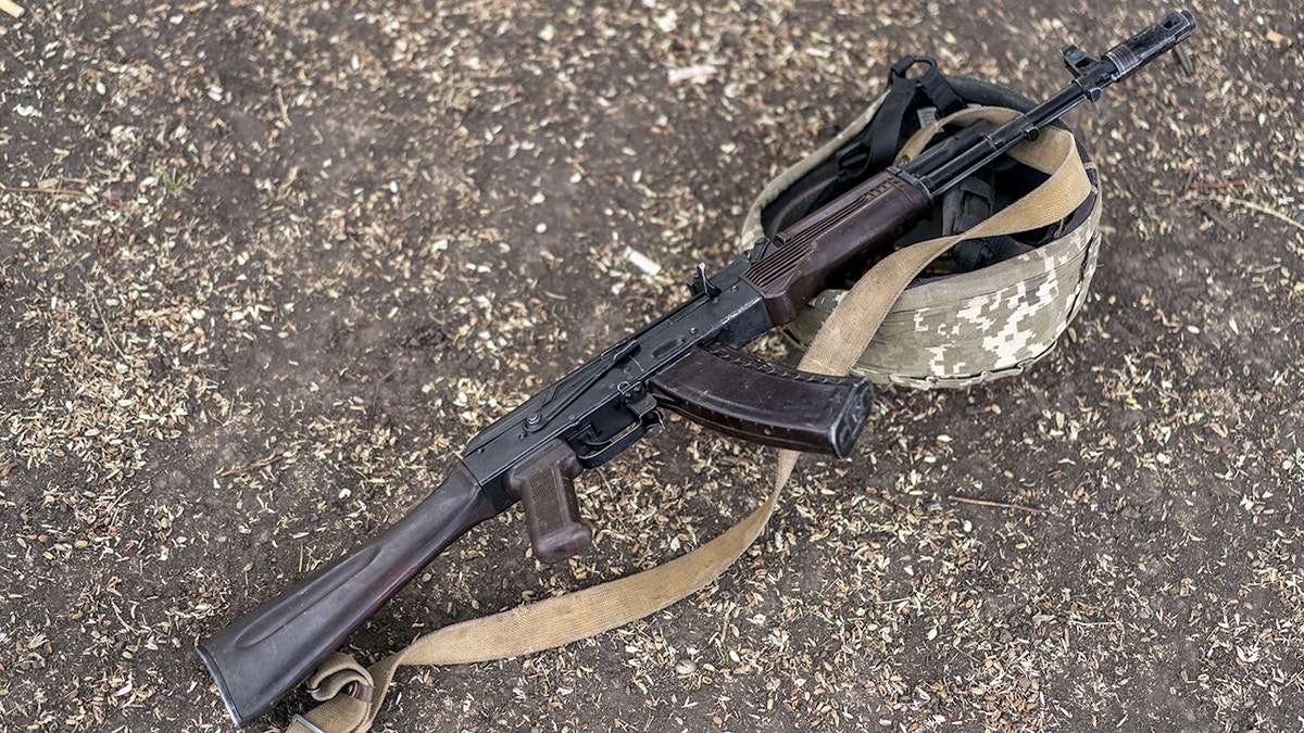 Kalashnikov rifle and helmet belonging to Ukrainian soldier