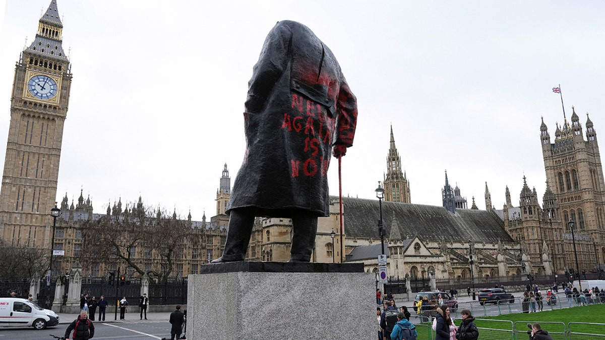 A statue of Winston Churchill covered in graffiti