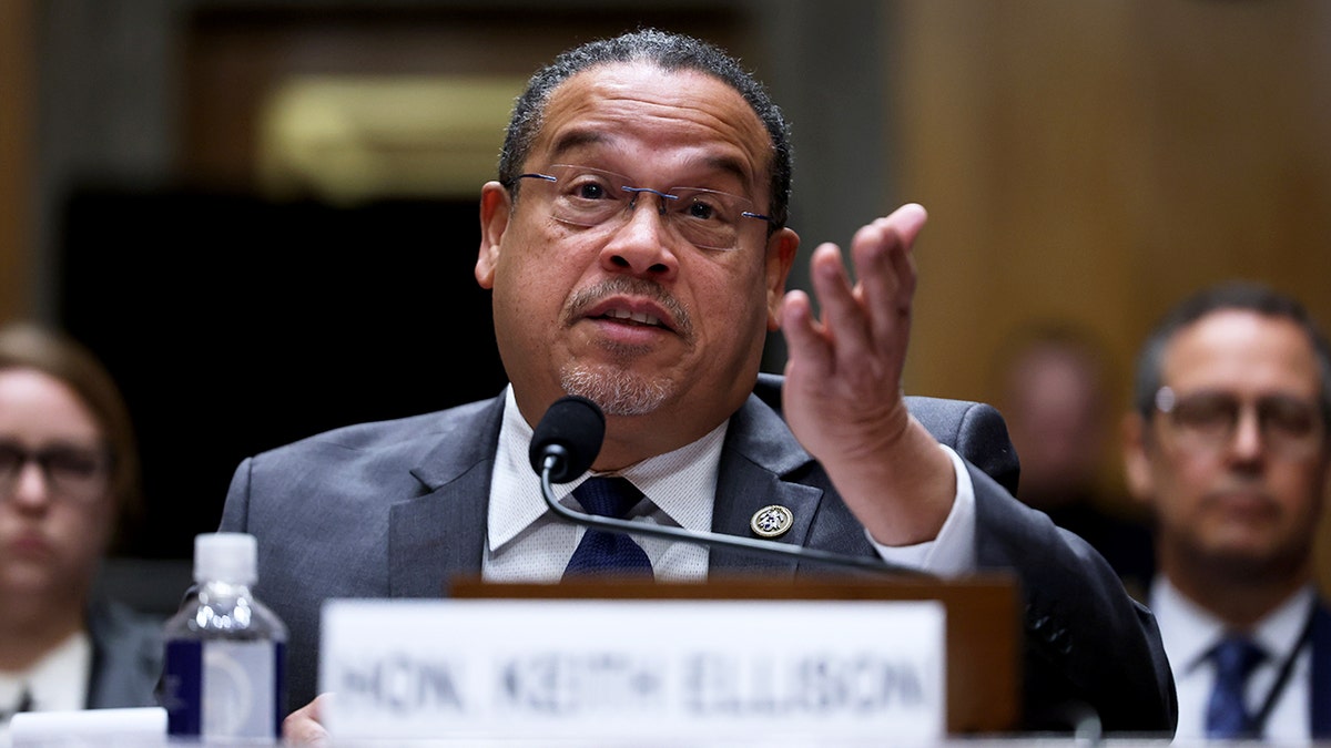 Minnesota Attorney General Keith Ellison raises hand while speaking