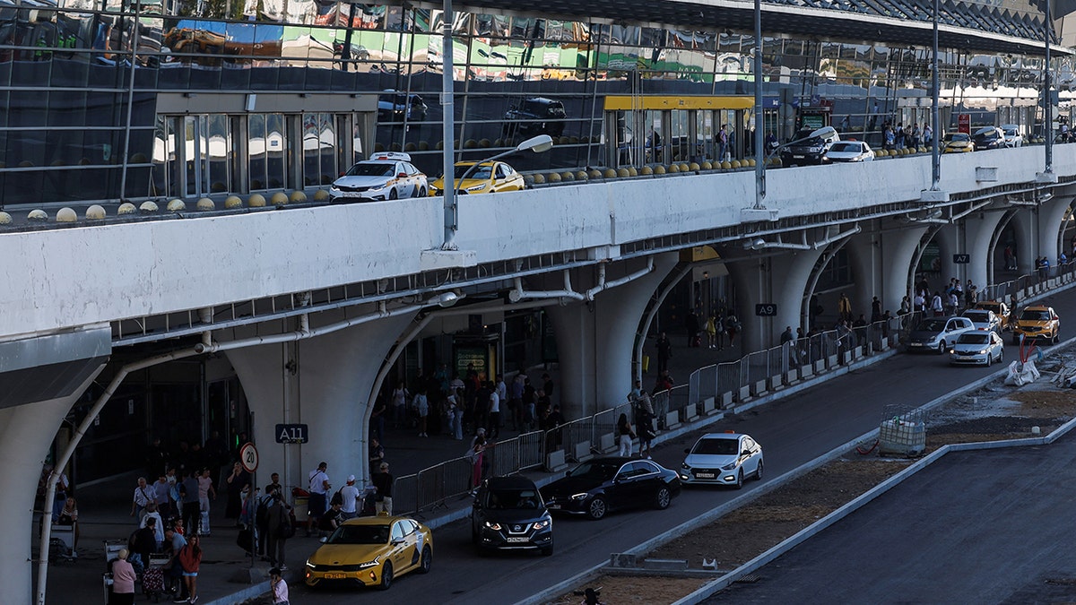People and cars at terminal of Moscow's Vnukovo airport